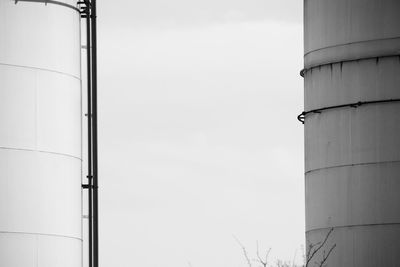 Low angle view of storage tank against sky