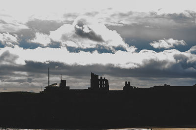 Low angle view of silhouette buildings against sky during sunset