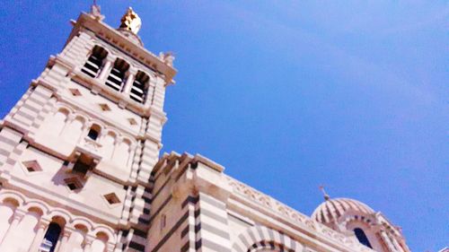 Low angle view of building against clear blue sky