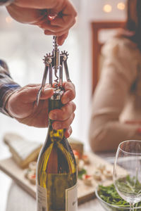 Midsection of man holding glass bottle