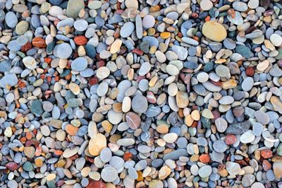 Colorful pebble stones texture by the beach