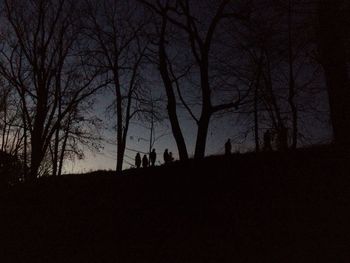 Silhouette bare trees against sky at sunset