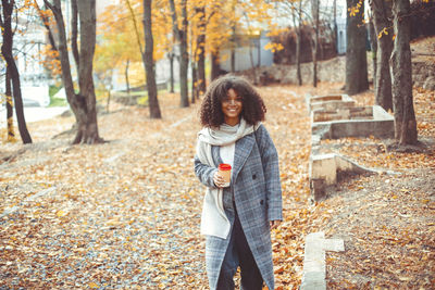 Rear view of woman standing in park