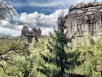 Low angle view of rock formation against sky