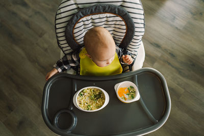 High angle view of boy sitting on slide