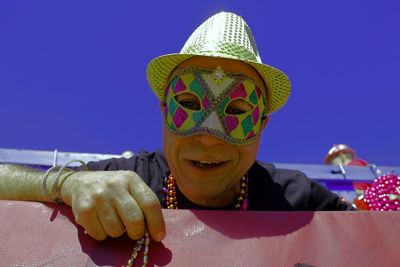 Close-up of man wearing mask against clear sky