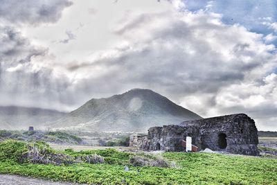 View of old ruins against cloudy sky