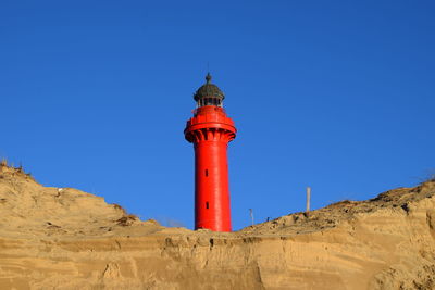 Low angle view of lighthouse against clear blue sky