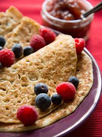Close-up of crepes with blueberries and raspberries on table