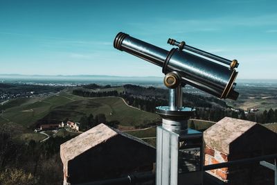 Coin-operated binoculars against sky