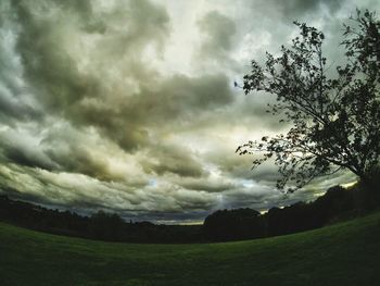 Scenic view of field against cloudy sky