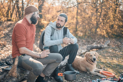 Man and dog sitting outdoors