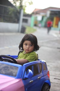 Portrait of cute girl in car