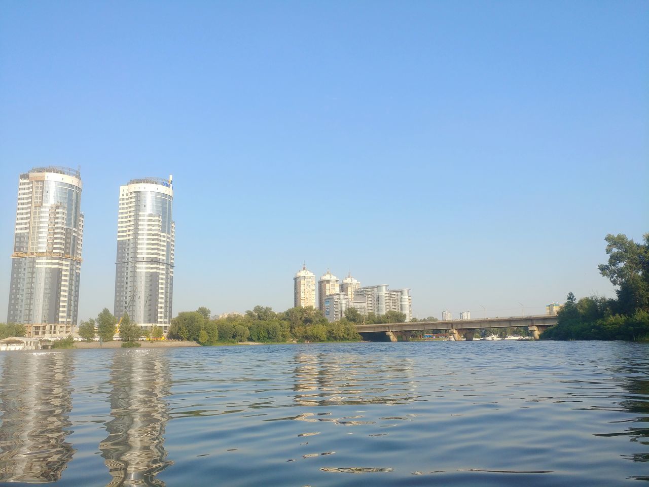 building exterior, architecture, built structure, water, sky, clear sky, waterfront, building, city, nature, copy space, office building exterior, no people, reflection, day, river, skyscraper, outdoors, office, modern, financial district