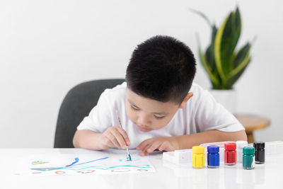 Portrait of boy looking at table