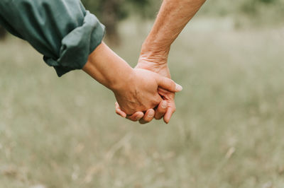 Happy senior couple holding hands. hands man and woman hold each other. romance and love in family