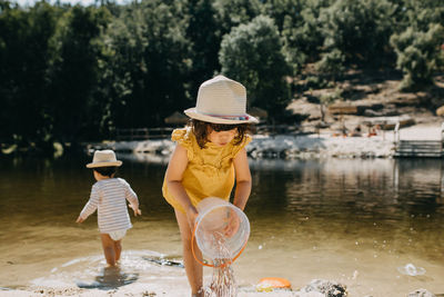 Brother and sister playing in the river