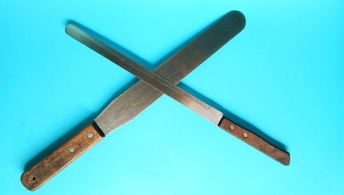 High angle view of pencil on table against blue background