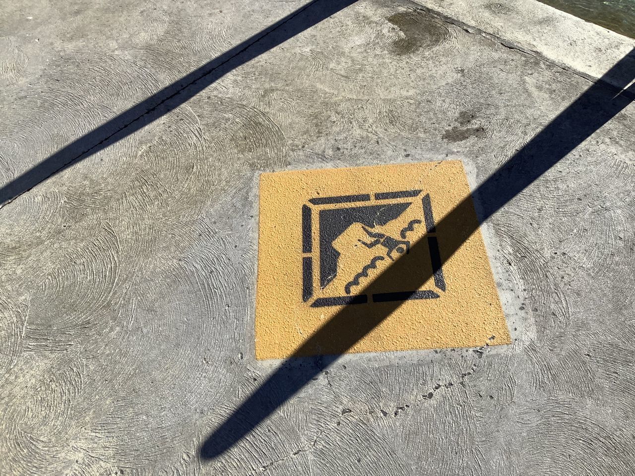 HIGH ANGLE VIEW OF YELLOW ARROW SIGN ON ROAD