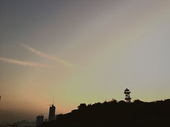 Low angle view of silhouette trees against sky at sunset