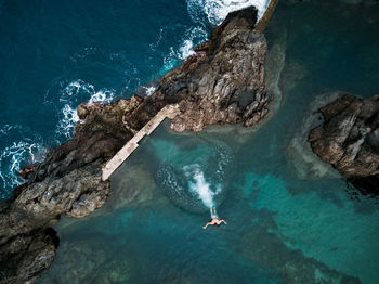 High angle view of woman swimming in sea