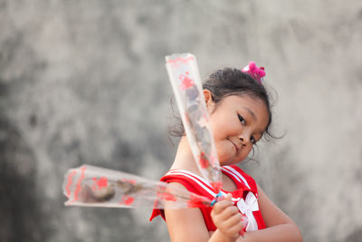 Portrait of cute girl against blurred background