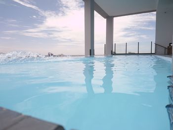 Infinity pool against cloudy sky