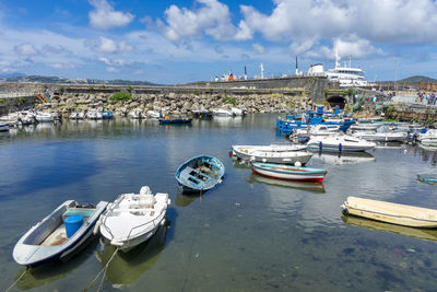 Sailboats moored in harbor