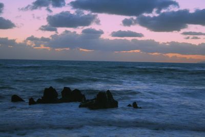 View of seascape against cloudy sky