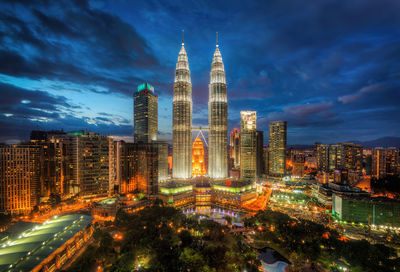 Aerial view of illuminated buildings in city at night