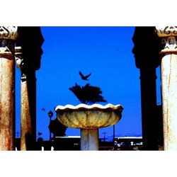 Close-up of a sculpture against blue sky