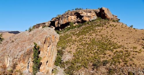 Low angle view of rock formation against sky