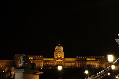 Illuminated city against clear sky at night