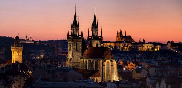 City at sunset with castle in background