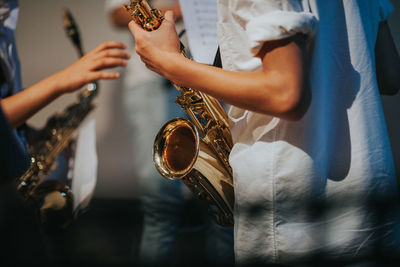 Midsection of man playing guitar