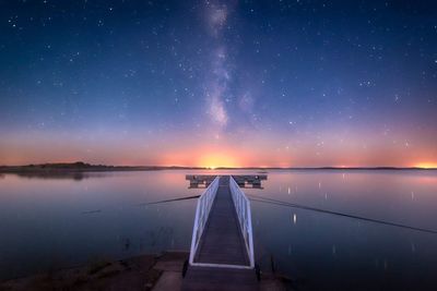 Scenic view of lake against sky at night