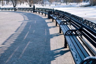 High angle view of empty park bench during winter