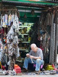 Full length of man sitting at market