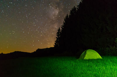 Scenic view of field against sky at night