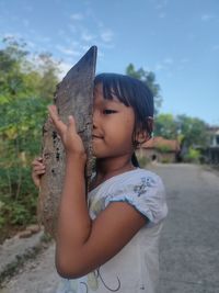 Boy holding girl standing outdoors
