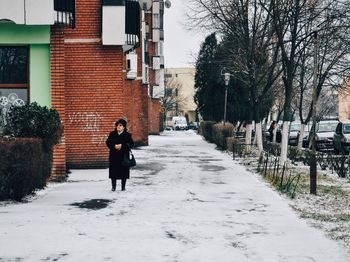 People walking on footpath in city