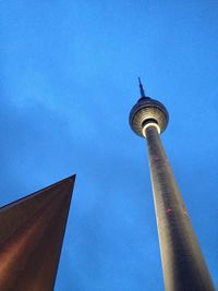 Low angle view of tower against blue sky