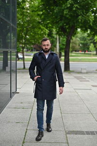 Full length portrait of a man walking outdoors