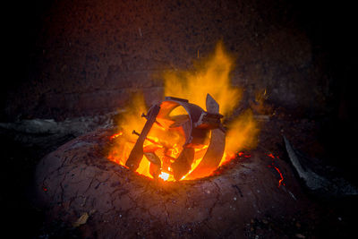 Bonfire on wooden log at night