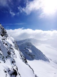 Scenic view of snowcapped mountains against sky