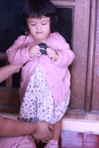 Full length of woman holding girl