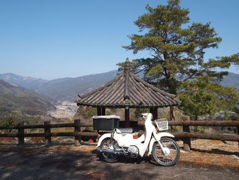 Bicycle parked against mountain range against clear sky