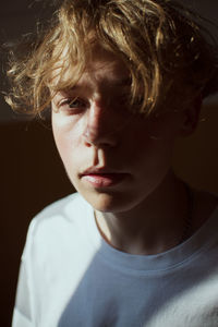 Close-up portrait of sad young man at home