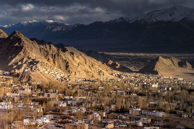 High angle view of townscape and mountains against sky