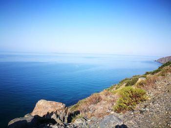 Scenic view of sea against clear blue sky